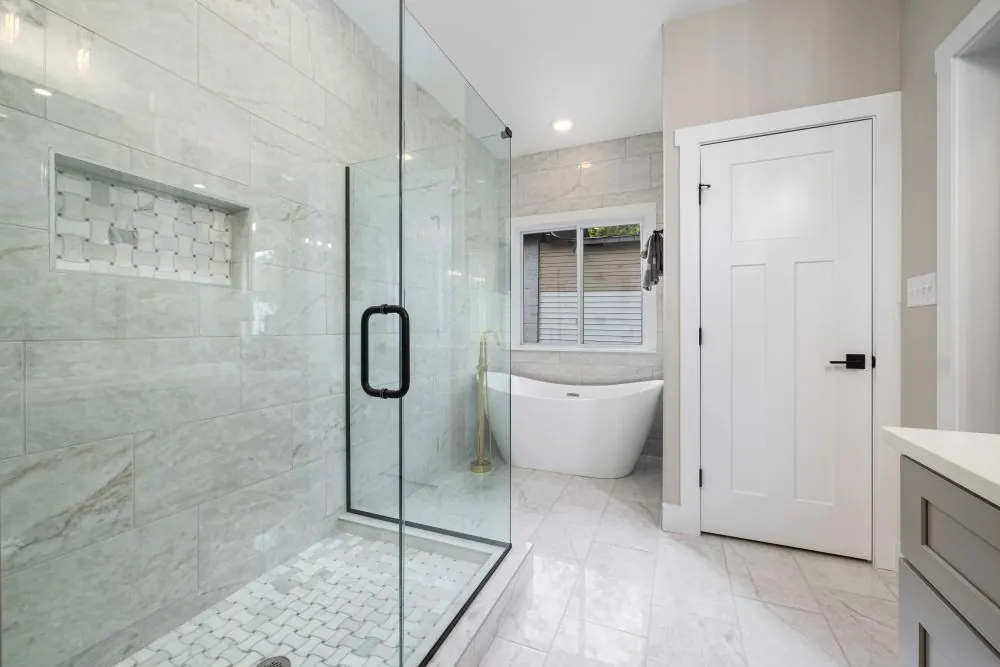 A marble bathroom with a glass shower